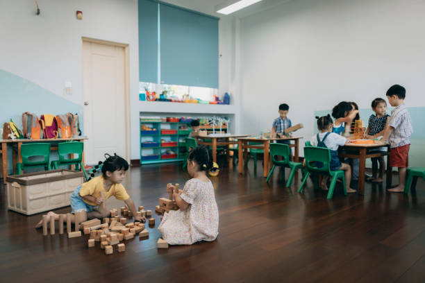 istock Preschool children playing with teaching aids in classroom 1417548060