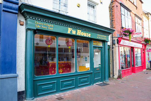 Holywell, Flintshire, UK: Aug 14, 2022: The Fu House Chinese Takeaway is neighbours with Reid and Roberts estate agency on the High Street