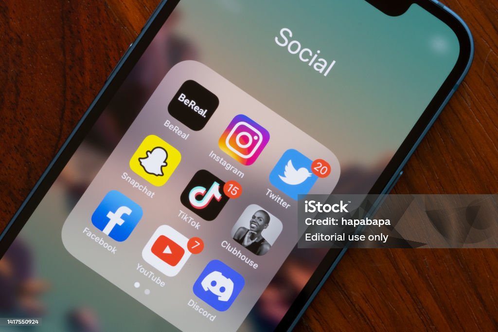 Social Media Apps - BeReal and Others Portland, OR, USA - Aug 23, 2022: Assorted popular social media apps - BeReal, Instagram, Twitter, Snapchat, TikTok, Clubhouse, Facebook, YouTube, and Discord - are seen on an iPhone. BeReal is a French social media app rising in popularity, and can be anti-social in some ways. Users receive a notification at a random time once a day saying 'Time to BeReal'. This opens up a two-minute window for the user to post a picture of what they are currently doing. The purpose of this is to capture an authentic, unfiltered snapshot of a user's life. Social Media Stock Photo