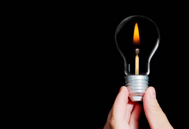 Light bulb in human hand, b&w.