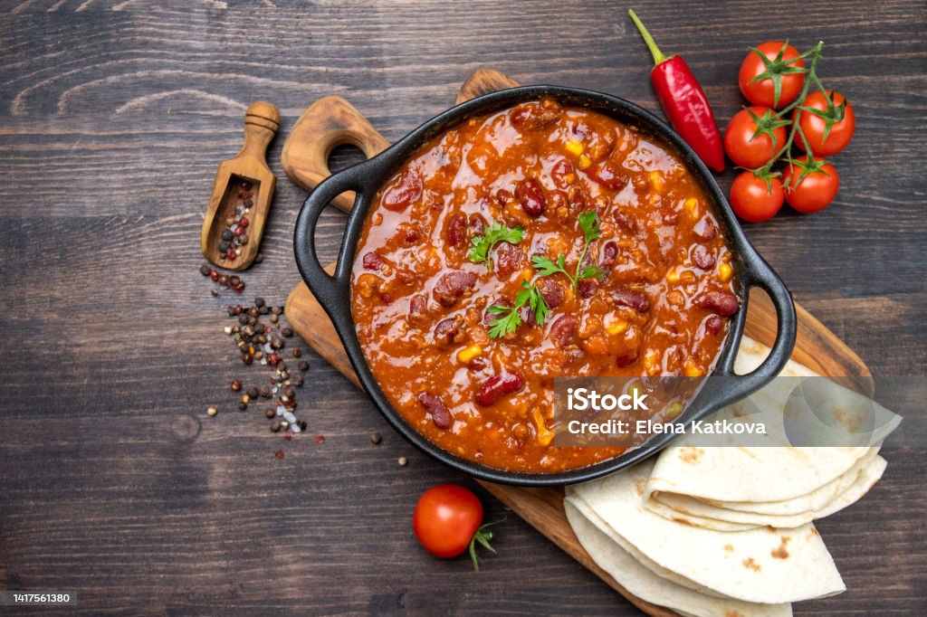 Bean and corn soup or ragout, red bean stew on a wooden background. Food Protein Vegan dish Bean and corn soup or ragout, red bean stew Chili Con Carne Stock Photo