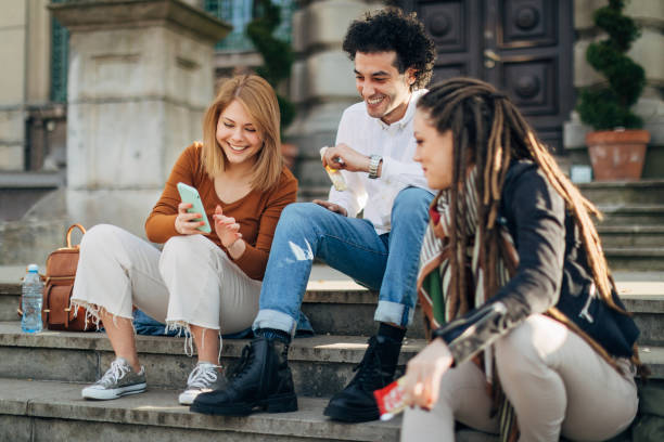 istock While sitting on the stairs, a group of students eat chocolate and enjoy a break from studying 1417561465