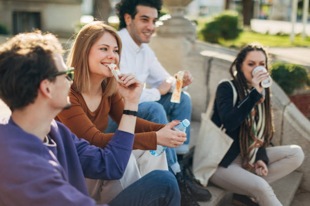 istock A multiracial group of best friends enjoy drinking coffee from a disposable cup while sitting on the stairs 1417561774