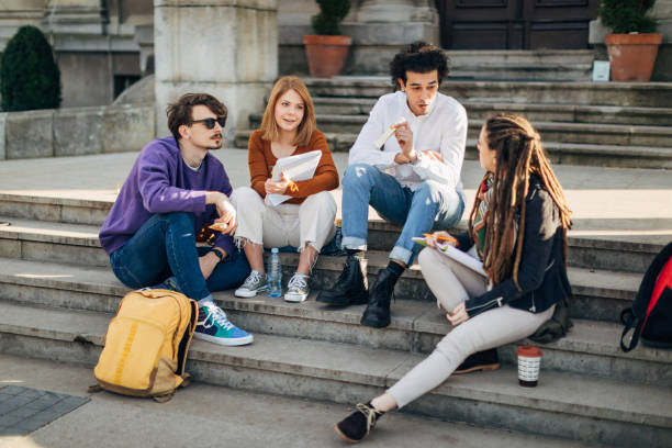 istock A diverse group of students take a break from studying by sitting on the stairs and chatting 1417561780