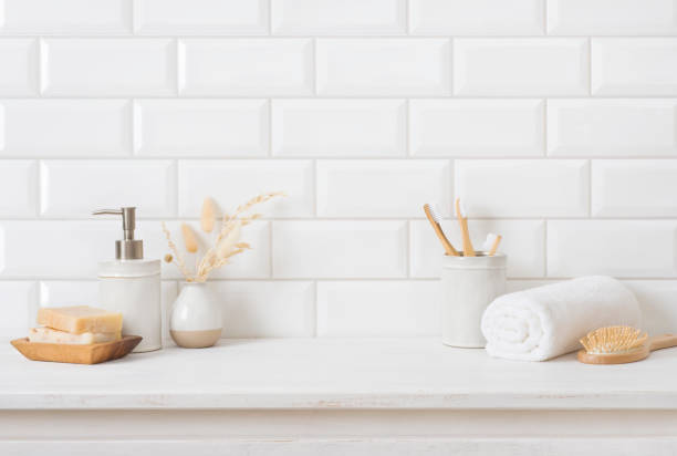 Tile wall and shelf in bathroom with various hygiene accessories stock photo