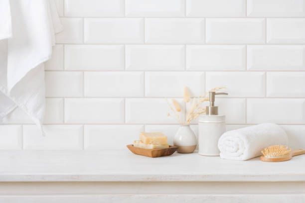 istock Hygiene accessories on wooden table in bathroom over tile wall 1417563478