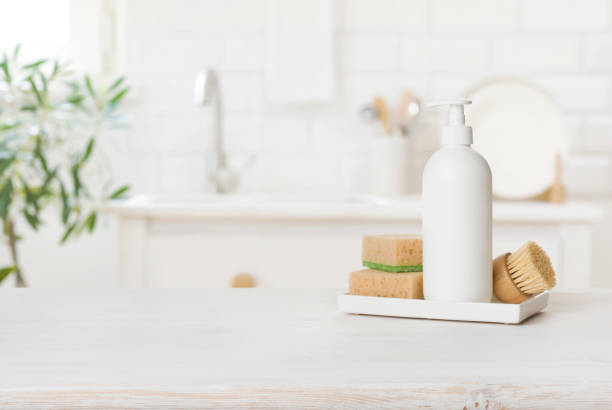 istock White plastic dishwashing gel bottle with sponges on kitchen table 1417563956