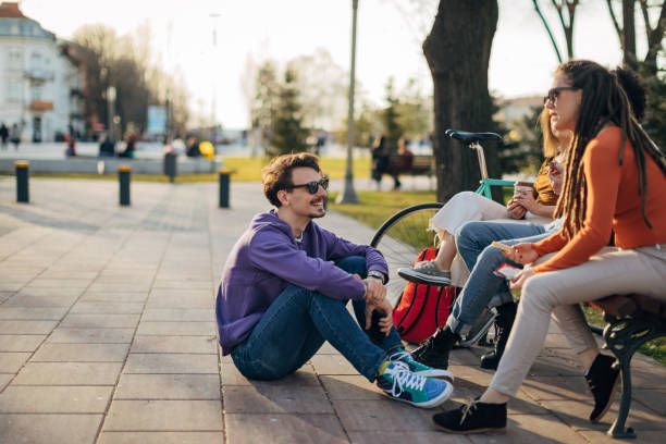 istock A group of students take a break from studying by hanging out in the park 1417564844