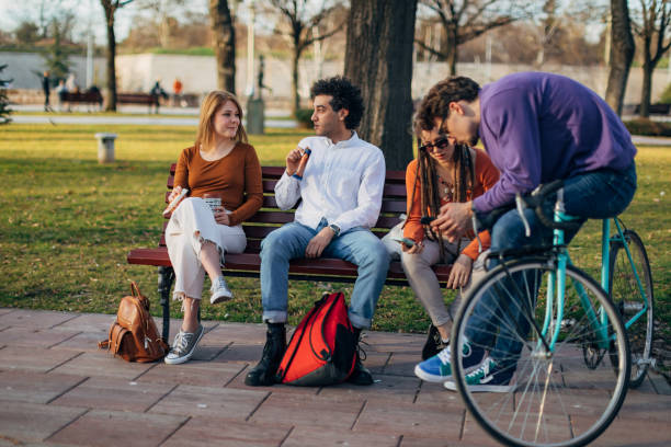 istock While two young people chat, the other two look at mobile phones and talk 1417565005