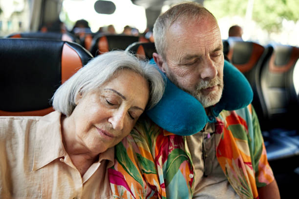 senior couple napping on motor coach - bus coach bus travel tour bus imagens e fotografias de stock