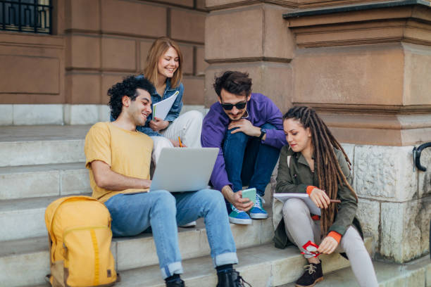 istock A multiracial and smaller group of students sitting on the stairs taking a break from studying 1417566199