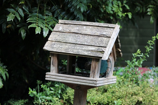 A closeup of a wooden birdhouse