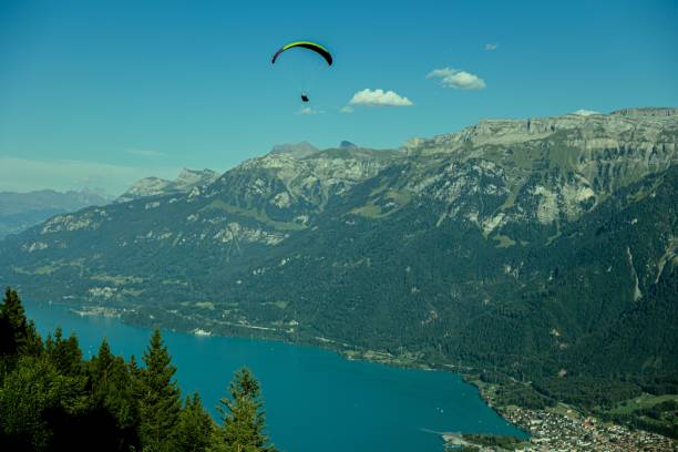 istock Paraglider above a lake surrounded by mountains 1417570705