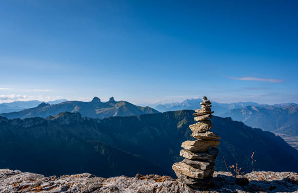 Landscape with mountain, sky and clouds. Rock Balancing, Stone Stacking Art. Land art. Rochers de Naye, Montreux, Switzerland in summer.