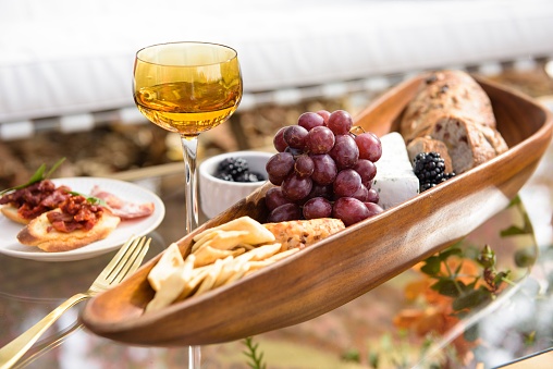 A vertical shot of tasty lunch, a fall cheese board with grapes