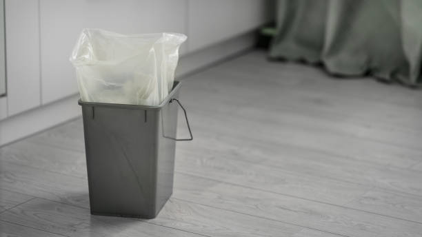 istock Trash bin with plastic package stands on wooden floor at home 1417577288
