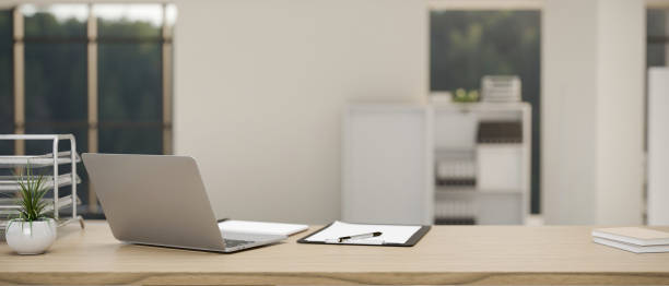 istock Modern office desk workspace with laptop, office accessories and space on wooden tabletop 1417580024