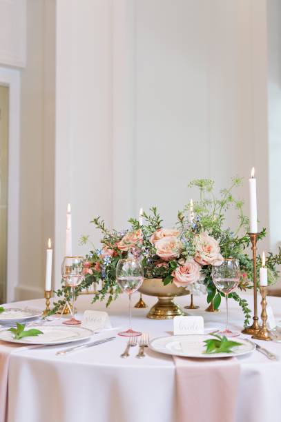 istock Vertical shot of a round wedding style reception table lit with elegant candles 1417580211