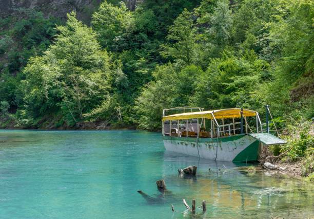 istock Old boat on beautiful river in Albania 1417580477
