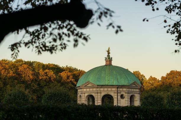 istock Munich hofgarden cathedral during sunset, framed by trees 1417581606