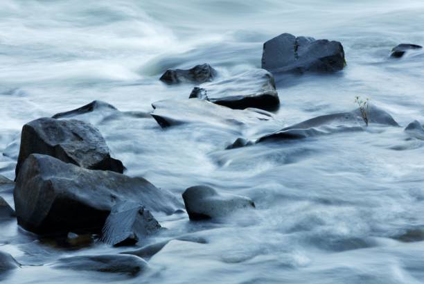 istock Closeup of water flowing through rocks 1417582371