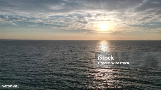 A Boat Wathcing The Sunrise Stock Photo - Download Image Now - Abstract, Beach, Beauty