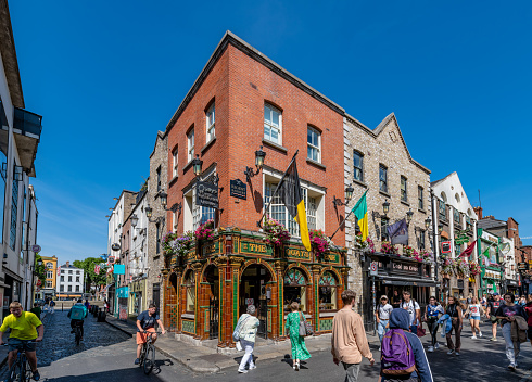 Dublin, Ireland. 9 August 2022. Tourists walk by a traditional Irish Pub in Temple Bar in Dublin