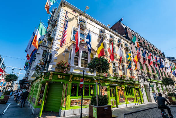 Dublin, Ireland. 9 August 2022. Tourists walk by a traditional Irish Pub in Temple Bar in Dublin