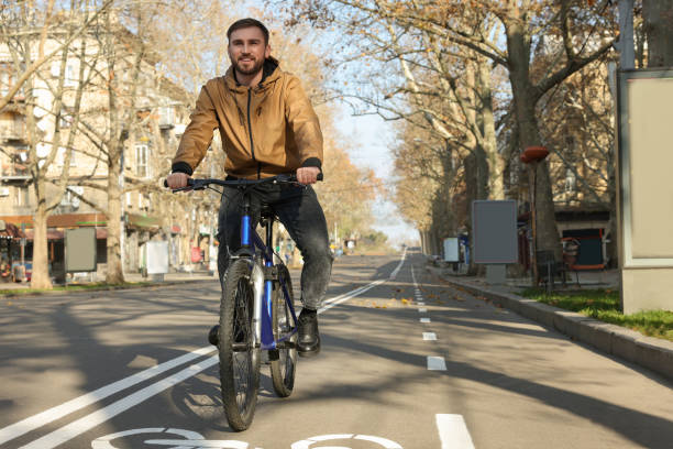 istock Happy handsome man riding bicycle on lane in city 1417585302