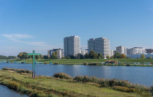 istock Cross next to a river with buildings in the background 1417586197