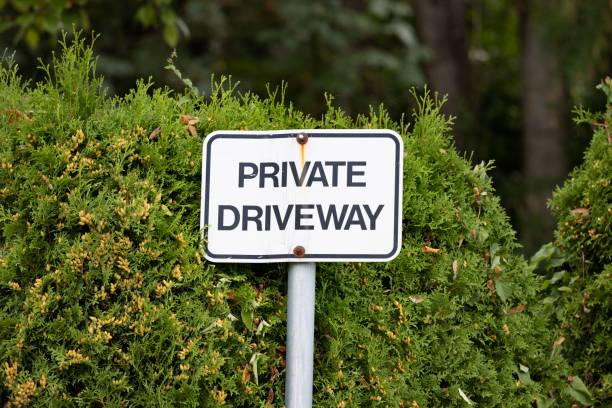 istock Private driveway sign with shrubs behind it 1417586745