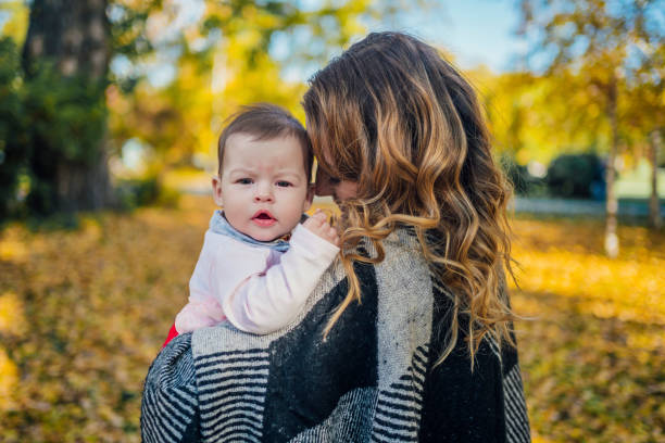 istock Mother with her baby in the park 1417586767