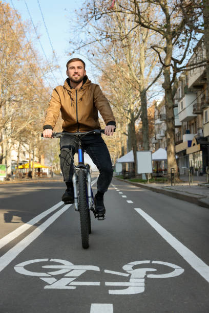 istock Happy handsome man riding bicycle on lane in city 1417586768