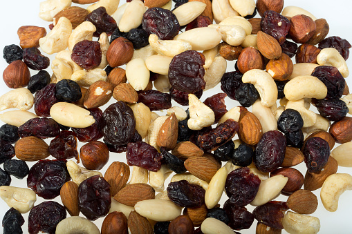 mixed nuts and dried fruits isolated on white background