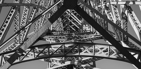 A low-angle shot of a detail of steel construction of the Eiffel Tower