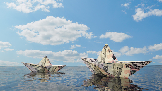 Paper Boats Made of Us Dollat Bills Floating on an Open Sea. 3D Render