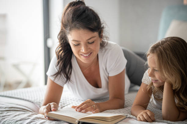 istock Pregnant mom on bed with daughter 1417595325