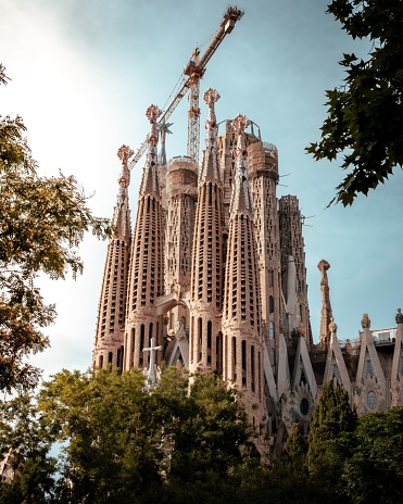 A low-angle shot of the Sagrada Familia during repairing