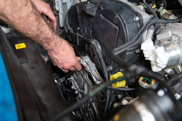 istock Auto mechanic hands screws the engine mount after replace the timing belt. 1417598056