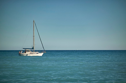 Sail, closeup and a boat on the water for travel, luxury cruise or adventure during summer. Sailing, ship and a yacht on the ocean for a holiday, vacation or to explore nature at sea