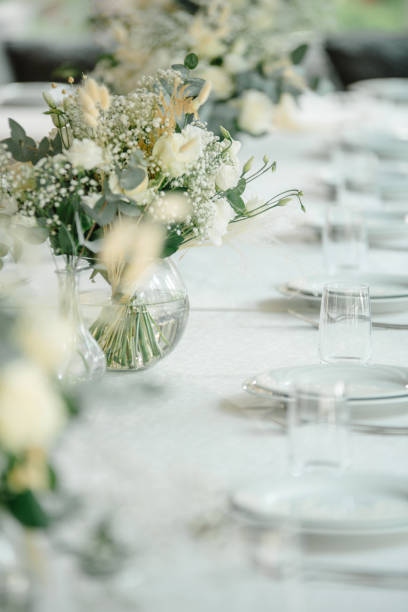istock Wedding reception table in the restaurant decorated with white candles and flowers 1417603303