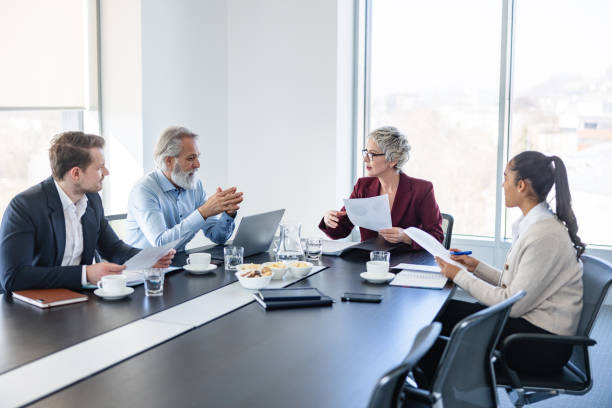 istock Female Manager Standing Addressing Colleagues At Office 1417603743