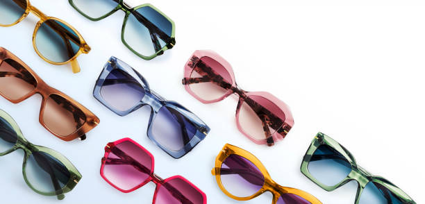 istock Sunglasses composition in many bright colors in transparent plastic. Top view with shadow. Trendy glasses isolated on white background. Glasses with polarized lenses. Fashionable eyewear for women. 1417603782