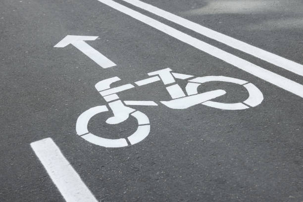 istock Bicycle lane with sign and arrow pointing direction on asphalt, closeup 1417605612