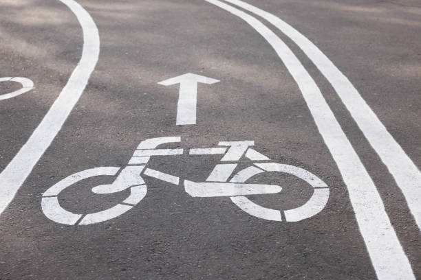 istock Bicycle lane with sign and arrow pointing direction on asphalt 1417605785