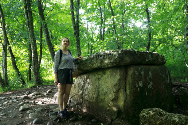 istock Woman posing next to dolmen in summer 1417605901