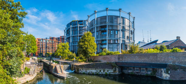 London apartments overlooking Regent's Canal King's skyline cityscape panorama Redeveloped apartments overlooking Regent’s Canal and Coal Drop Yard in King’s Cross, London. regents canal stock pictures, royalty-free photos & images