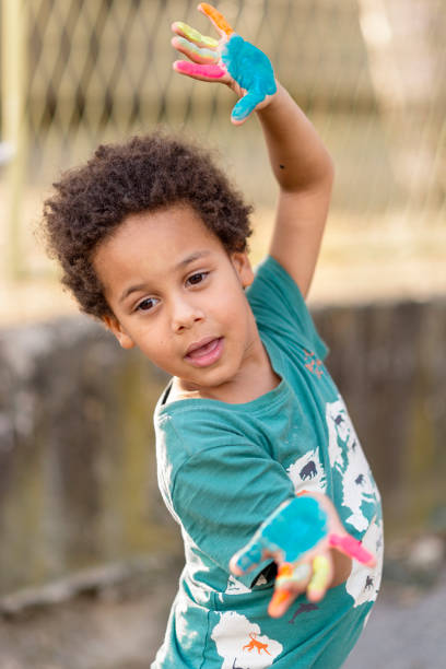 istock beautiful happy boy with painted hands 1417606792