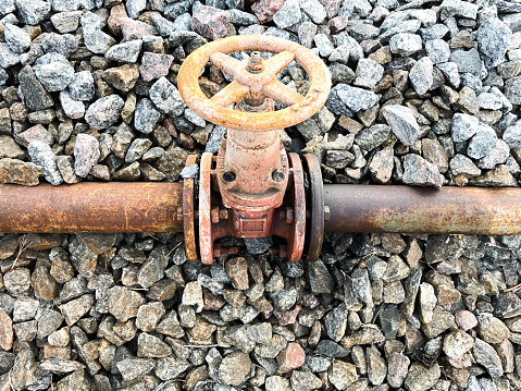 Gas pipe with a valve for regulating the supply of energy resources, side view , communication of the pipeline with a valve for closing or opening ,crushed stone helps to hold the pipe