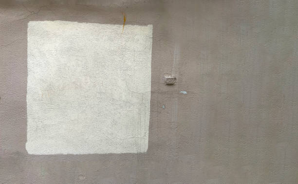 istock White paint drips on a gray background, brush strokes are visible, with which the man painted the wall, white on gray, wall repair, drawing, colored paint, flows down the wall,a place for advertising 1417607843